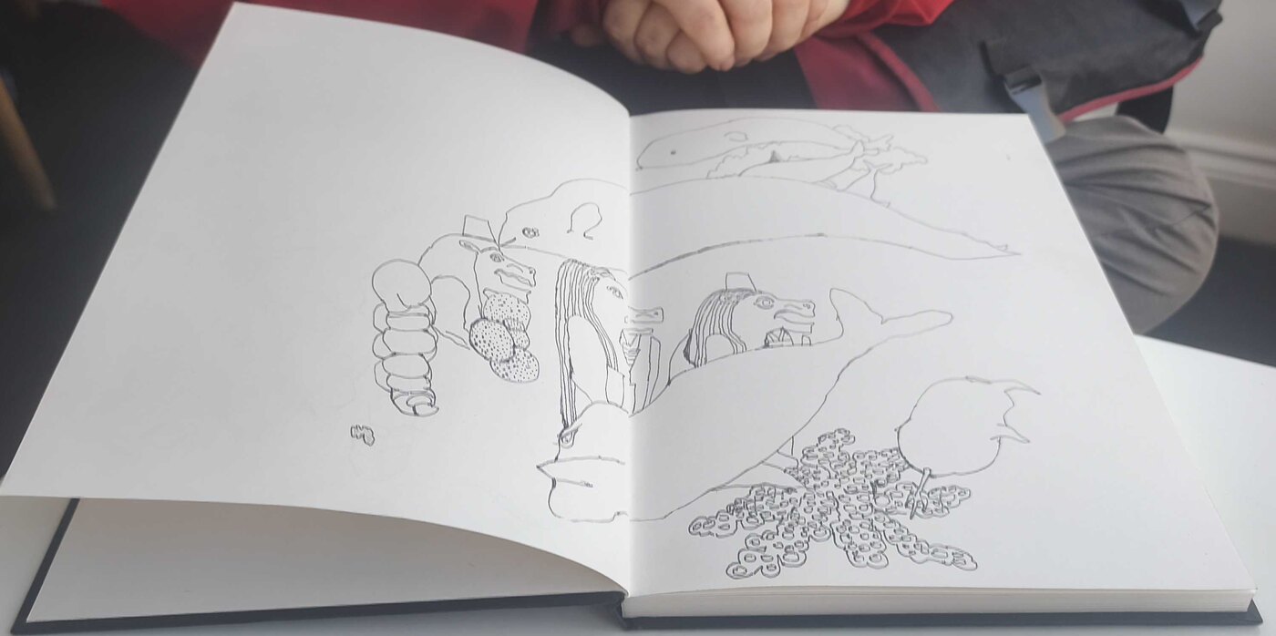 Open sketchbook spread with flowing abstract pen drawings
